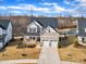 Aerial front elevation featuring manicured lawn and a two-car garage at 525 Marion Hills Way, Knightdale, NC 27545
