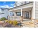 Charming covered front porch with stone columns and beautiful landscaping at 525 Marion Hills Way, Knightdale, NC 27545