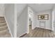 Bright hallway features wood floors, access to the laundry room, and a staircase to the upper level at 525 Marion Hills Way, Knightdale, NC 27545