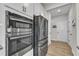 Stainless steel appliances featuring double oven and refrigerator in a modern kitchen setting at 525 Marion Hills Way, Knightdale, NC 27545