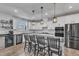 Well-lit kitchen with stainless steel appliances, a central island, and stylish pendant lights at 525 Marion Hills Way, Knightdale, NC 27545