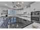 Bright kitchen features white cabinets, gray countertops, and stainless steel appliances at 525 Marion Hills Way, Knightdale, NC 27545