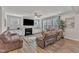 Comfortable living room features plush sofas, a fireplace, a ceiling fan, and bright windows at 525 Marion Hills Way, Knightdale, NC 27545