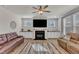 Bright living room with a fireplace, built-in cabinets, and comfortable seating offers a relaxing and stylish living space at 525 Marion Hills Way, Knightdale, NC 27545