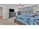 Comfortable main bedroom featuring a ceiling fan, large windows, and carpeted floor at 525 Marion Hills Way, Knightdale, NC 27545