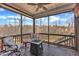 Relax on the porch, featuring a ceiling fan, comfortable seating, and views of the wooded scenery at 525 Marion Hills Way, Knightdale, NC 27545