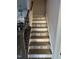 Elegant staircase with decorative tile risers and wooden handrail adds a touch of sophistication at 525 Marion Hills Way, Knightdale, NC 27545