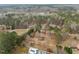 Drone shot of the vast, wooded community with views of homes, storage barns, and private inground pools at 582 Pollyanna Rd, Henderson, NC 27537
