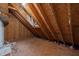 Spacious unfinished attic with exposed wood beams offers potential for storage or customization at 582 Pollyanna Rd, Henderson, NC 27537