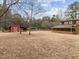 Large backyard featuring a storage barn, various carports, and a covered outdoor patio attached to the home at 582 Pollyanna Rd, Henderson, NC 27537
