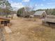 Large fenced backyard with an expansive lawn, mature trees, and other outbuildings at 582 Pollyanna Rd, Henderson, NC 27537