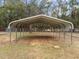 Metal carport on a grassy lot, providing practical outdoor parking and shelter from the elements at 582 Pollyanna Rd, Henderson, NC 27537