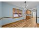 Charming dining room with hardwood floors, modern lighting, and a large window providing natural light and an airy feel at 582 Pollyanna Rd, Henderson, NC 27537