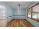 Elegant dining room featuring hardwood floors, contemporary lighting, and large windows, perfect for Gathering gatherings at 582 Pollyanna Rd, Henderson, NC 27537