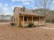 Exterior view of the home with a tidy yard and a classic design, highlighted by natural light and a cozy porch at 582 Pollyanna Rd, Henderson, NC 27537