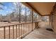 Inviting front porch with wooden floor and railings offering a serene outdoor space and a view of the yard at 582 Pollyanna Rd, Henderson, NC 27537