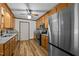 Well-lit kitchen features granite counters, stainless steel appliances, and a wooden ceiling fan at 582 Pollyanna Rd, Henderson, NC 27537
