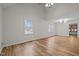 Spacious living room with large windows, hardwood floors, and neutral walls, offering a bright and airy atmosphere at 582 Pollyanna Rd, Henderson, NC 27537