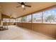 Spacious enclosed back patio with views of the property and three ceiling fans at 582 Pollyanna Rd, Henderson, NC 27537