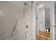 Shower area boasts clean white tiling and silver fixtures, enhanced by an open doorway view at 582 Pollyanna Rd, Henderson, NC 27537