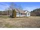 Inviting single-story home featuring light gray vinyl siding and well-kept yard, blending comfort and curb appeal at 59 Tristan Dr, Kenly, NC 27542