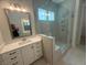 Bright bathroom with walk-in glass shower, vanity with storage, and modern fixtures at 60 Valebrook Ct, Youngsville, NC 27596