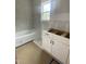 Bathroom showing the tub and cabinets, and window providing natural light at 60 Valebrook Ct, Youngsville, NC 27596