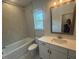 Bathroom with shower/tub combo, light grey tile, and a white vanity at 60 Valebrook Ct, Youngsville, NC 27596