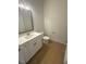 Cozy half bathroom with white cabinets, granite countertops, and modern fixtures at 60 Valebrook Ct, Youngsville, NC 27596
