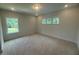 A light and airy bedroom featuring a neutral carpet and multiple windows at 60 Valebrook Ct, Youngsville, NC 27596