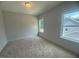 A light and airy bedroom featuring neutral carpet and two windows at 60 Valebrook Ct, Youngsville, NC 27596
