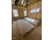 Bright bedroom under construction, featuring framing, wood floor, and natural light from multiple windows at 60 Valebrook Ct, Youngsville, NC 27596