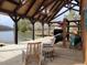 View of boathouse with canoe and kayak storage and outdoor rocking chairs at 60 Valebrook Ct, Youngsville, NC 27596