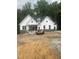 Charming new construction home with white siding and stone accents on a spacious lot at 60 Valebrook Ct, Youngsville, NC 27596