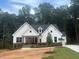 New construction home with white board and batten siding and covered front porch at 60 Valebrook Ct, Youngsville, NC 27596