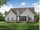 Charming home with gray siding, stone accents, and a well-manicured lawn at 60 Valebrook Ct, Youngsville, NC 27596