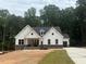 Beautiful two-story home with white siding, stone accents, and a lush green lawn at 60 Valebrook Ct, Youngsville, NC 27596