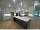 Spacious kitchen with a large center island, stainless steel appliances, and custom cabinetry at 60 Valebrook Ct, Youngsville, NC 27596