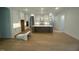 Open concept kitchen with white cabinets, a large island, stainless steel appliances, and hardwood floors at 60 Valebrook Ct, Youngsville, NC 27596