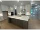 Modern kitchen with white cabinets, a large island, stainless steel appliances, and pendant lighting at 60 Valebrook Ct, Youngsville, NC 27596