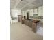 Spacious kitchen area with unfinished island and white cabinets awaiting installation at 60 Valebrook Ct, Youngsville, NC 27596