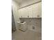 Functional laundry room with white cabinets, sink, and tile flooring at 60 Valebrook Ct, Youngsville, NC 27596