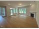 Bright living room with hardwood floors, a fireplace, and large windows overlooking the backyard at 60 Valebrook Ct, Youngsville, NC 27596