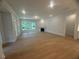 Bright living room boasts a fireplace and large windows, offering ample natural light and wood floors at 60 Valebrook Ct, Youngsville, NC 27596