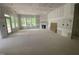 Large living room featuring a fireplace, multiple windows, and a door leading outside at 60 Valebrook Ct, Youngsville, NC 27596