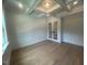An office featuring a coffered ceiling, wainscotting, and glass paneled doors at 60 Valebrook Ct, Youngsville, NC 27596
