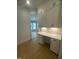Cozy office space with white built-in cabinets, a desk, and hardwood floors at 60 Valebrook Ct, Youngsville, NC 27596