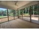 A spacious screened porch with a ceiling fan overlooking a wooded lot at 60 Valebrook Ct, Youngsville, NC 27596