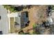 Aerial view of property with a well maintained lawn, paved driveway and lush mature trees at 613 Flaherty Ave, Wake Forest, NC 27587