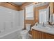 Cozy bathroom featuring a tub-shower combo, single sink vanity, and neutral color palette at 613 Flaherty Ave, Wake Forest, NC 27587
